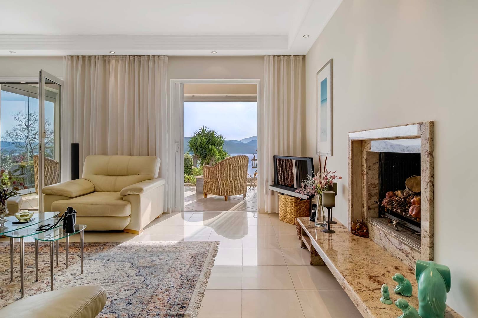 the living area exits to the sunlounge with sea views