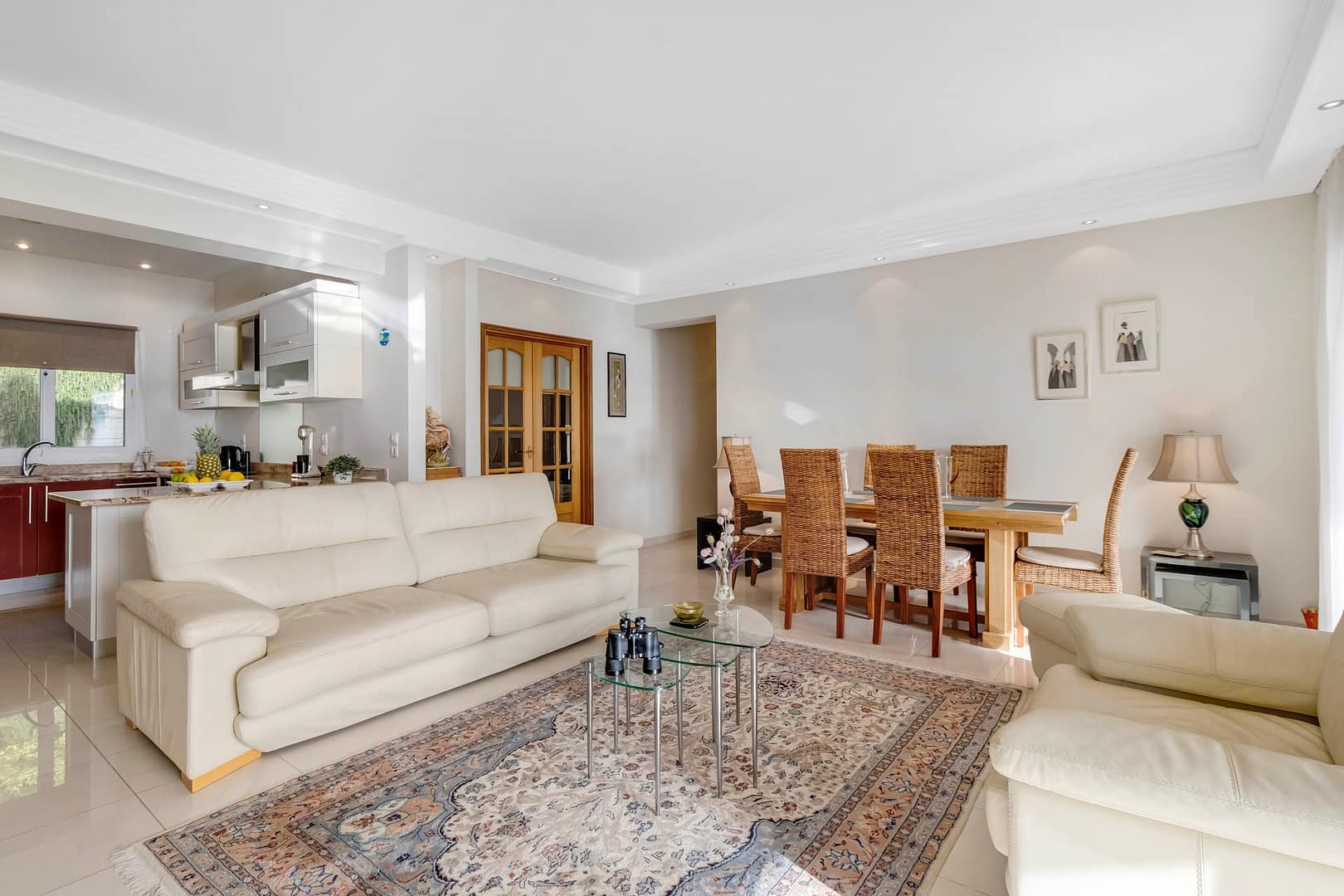 the wooden doors lead to the third bedroom